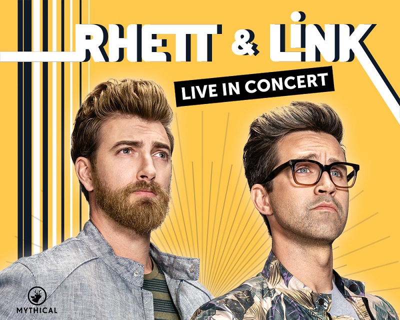 A blonde man and a brunette man with glasses stare off into the distance triumphantly. Text reads: "Rhett and Link Live"